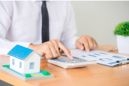 Advisor calculating retirement corpus and family wealth plan with calculator, notebook and financial documents at mutual fund advisory office in Kandivali West Mumbai